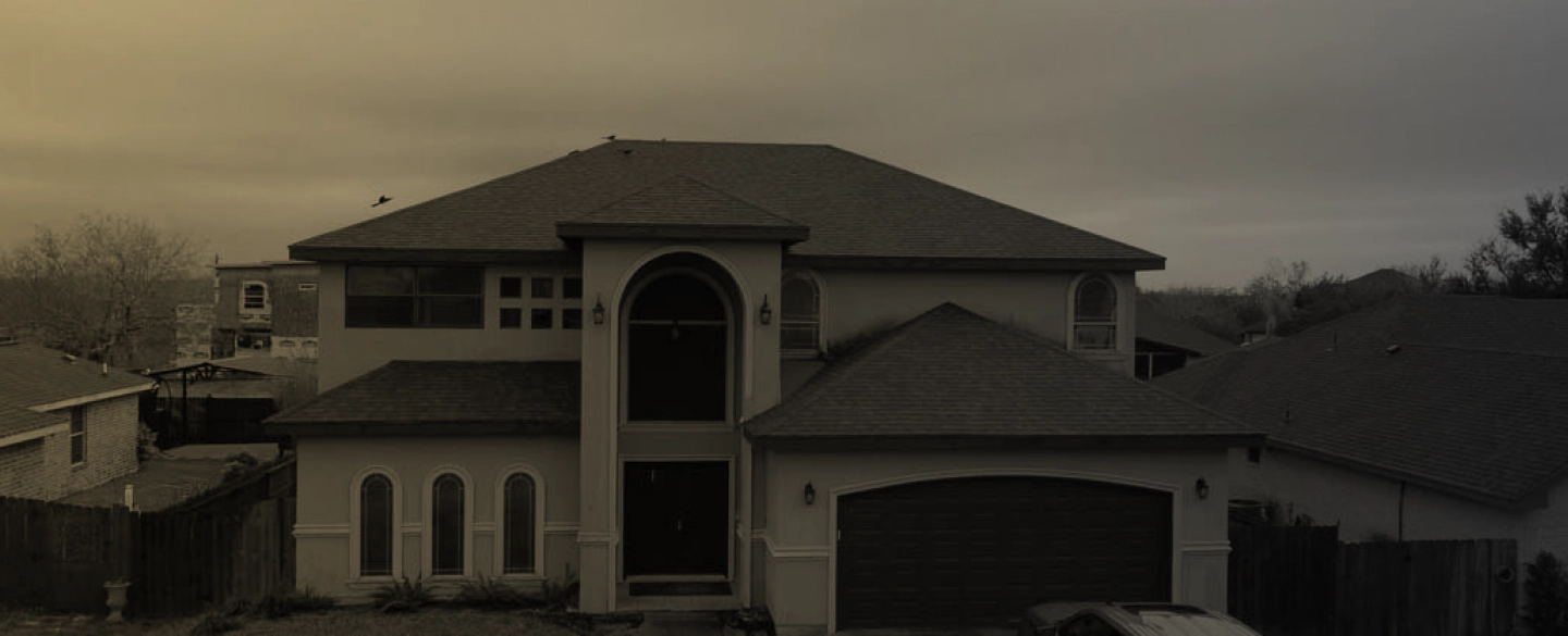 beige house with brown roofing a garage patio and a car outside