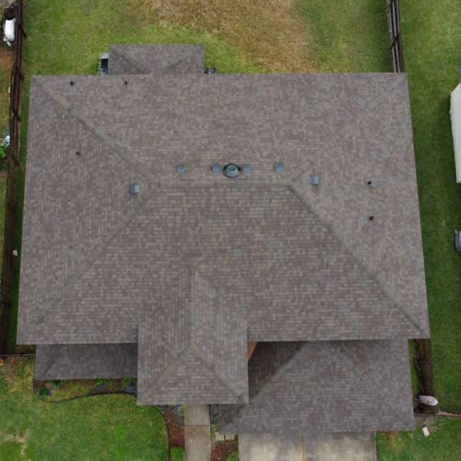 house with a light brown roofing with a big patio around